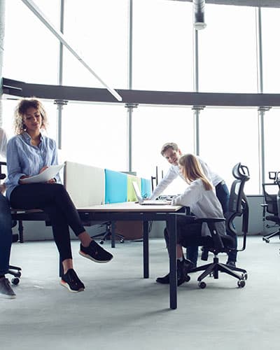 Regulatory consultants in a modern office meeting discussing compliance